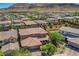 Aerial image of a home with an extensive backyard, manicured lawn, mature trees, and surrounding neighborhood at 10433 Ember Rose Ave, Las Vegas, NV 89135