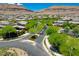 Scenic street view showcases the neighborhood's lush trees and meticulously manicured landscaping at 10433 Ember Rose Ave, Las Vegas, NV 89135
