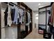 Well-organized walk-in closet with custom shelving, hanging rods, and carpet floors at 10433 Ember Rose Ave, Las Vegas, NV 89135