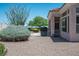 Spacious backyard featuring desert landscaping, a built-in grill, and mountain views at 10720 Bennington Ct, Las Vegas, NV 89134