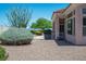Serene backyard featuring mature landscaping, a built-in grill, and comfortable patio seating, perfect for outdoor living at 10720 Bennington Ct, Las Vegas, NV 89134