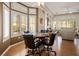 Cozy dining area features a round table, comfortable seating, and natural light from large windows at 10720 Bennington Ct, Las Vegas, NV 89134