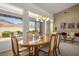 Formal dining room with an elegant chandelier, mountain views, and a formal living area at 10720 Bennington Ct, Las Vegas, NV 89134