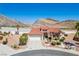 Beautiful desert home with mature landscaping, a tile roof, and mountain views in the background at 10720 Bennington Ct, Las Vegas, NV 89134