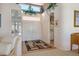 Inviting foyer with a view of the kitchen, double front doors, a decorative rug, and a high ceiling at 10720 Bennington Ct, Las Vegas, NV 89134