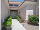 Welcoming front entrance with a secure gate, mature landscaping, and a paved walkway leading to the door at 10720 Bennington Ct, Las Vegas, NV 89134