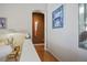Neutral hallway with hardwood floors, decorative artwork, and a view of the adjacent rooms at 10720 Bennington Ct, Las Vegas, NV 89134
