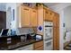 Well-appointed kitchen featuring oak cabinets, updated appliances, and granite countertops at 10720 Bennington Ct, Las Vegas, NV 89134
