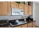 Modern kitchen features stainless appliances, dark countertops, and ample cabinet space for storage at 10720 Bennington Ct, Las Vegas, NV 89134
