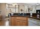 Eat-in kitchen features wooden cabinets, granite countertops, and natural light from the large bay window at 10720 Bennington Ct, Las Vegas, NV 89134