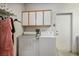 Functional laundry room features modern appliances, storage cabinets, and convenient access to the outside at 10720 Bennington Ct, Las Vegas, NV 89134