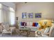 Cozy living room featuring comfortable seating, decorative pillows, artwork, and a glass-top coffee table at 10720 Bennington Ct, Las Vegas, NV 89134