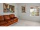 Inviting living room featuring a comfortable sofa and bright window with shutter at 10720 Bennington Ct, Las Vegas, NV 89134