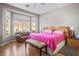 Serene main bedroom with large windows, cozy seating, and a comfortable bed for restful nights at 10720 Bennington Ct, Las Vegas, NV 89134