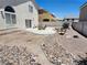 Backyard featuring a concrete patio, a small wooden bridge, and gravel landscaping at 10968 Geyser Peak St, Henderson, NV 89052