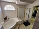 Corner garden tub with a glass-enclosed shower and a view into the walk-in closet at 10968 Geyser Peak St, Henderson, NV 89052