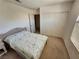 Bright bedroom with a light floral bedspread, sliding closet doors, and a window with blinds at 10968 Geyser Peak St, Henderson, NV 89052
