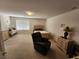 Large bedroom with a queen-sized bed, dresser, chair, and a bright window at 10968 Geyser Peak St, Henderson, NV 89052
