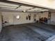 Spacious two-car garage with concrete flooring and ample storage space, accessible through a side door at 10968 Geyser Peak St, Henderson, NV 89052