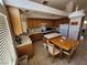 Traditional kitchen featuring light wooden cabinetry, tile countertops, white appliances, and an adjacent dining area at 10968 Geyser Peak St, Henderson, NV 89052