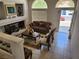 Cozy living room with tile floors, a decorative fireplace, and abundant natural light from front windows at 10968 Geyser Peak St, Henderson, NV 89052