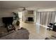 Spacious living room with tile floors, a fireplace, and sliding glass doors providing ample light at 10968 Geyser Peak St, Henderson, NV 89052