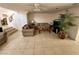 Spacious living room featuring tile flooring, comfortable sofas, and a staircase at 10968 Geyser Peak St, Henderson, NV 89052