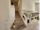 Carpeted staircase with white walls, leading to the upper level of the house at 10968 Geyser Peak St, Henderson, NV 89052