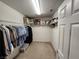 A fully organized walk-in closet with clothes racks and shelving for storage at 10968 Geyser Peak St, Henderson, NV 89052