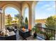 Cozy balcony with outdoor seating, a fire pit, and views of the lake and surrounding community at 11 Via Vita Bella, Henderson, NV 89011
