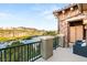 Balcony featuring stone finishes overlooking a lake, golf course, and mountain views at 11 Via Vita Bella, Henderson, NV 89011