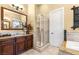 Luxurious bathroom with granite countertops, wood cabinets, and glass-enclosed shower at 11 Via Vita Bella, Henderson, NV 89011