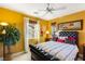 Inviting bedroom with a tufted headboard, bright, light filled windows, and a modern ceiling fan at 11 Via Vita Bella, Henderson, NV 89011