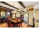Formal dining room with wooden beams, decorative windows, and elegant chandelier at 11 Via Vita Bella, Henderson, NV 89011