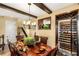 Dining room with wine storage, wooden beams, staircase and ornate chandelier at 11 Via Vita Bella, Henderson, NV 89011