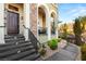 Inviting home entrance with elegant stone steps, wooden door, and lush landscaping at 11 Via Vita Bella, Henderson, NV 89011