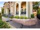 Attractive home entrance showcasing a sidewalk, manicured bushes, and stone accents at 11 Via Vita Bella, Henderson, NV 89011