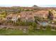 Beautiful exterior view of residences overlooking meticulously maintained green space, pool, and community gazebo at 11 Via Vita Bella, Henderson, NV 89011