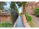 Side of home featuring a stone facade, walkway, and lush landscaping at 11 Via Vita Bella, Henderson, NV 89011