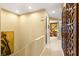 Hallway featuring decorative wall trim and access to a room with stylish furnishings at 11 Via Vita Bella, Henderson, NV 89011