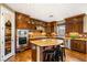 Spacious kitchen with dark wood cabinets, granite countertops and stainless steel appliances at 11 Via Vita Bella, Henderson, NV 89011