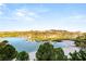 Wide lake with sandy beach and distant hills featuring tropical trees and clear skies at 11 Via Vita Bella, Henderson, NV 89011