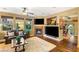 Comfortable living room with fireplace, mounted televisions and plush rug at 11 Via Vita Bella, Henderson, NV 89011