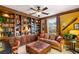 Comfortable living room with built-in wooden bookshelves, coffered ceiling and cozy seating at 11 Via Vita Bella, Henderson, NV 89011