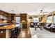 Open concept living space with stainless steel appliances, dark wood cabinetry and leather sofas at 11 Via Vita Bella, Henderson, NV 89011