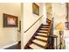 Elegant staircase featuring dark wood, neutral carpet and detailed railing at 11 Via Vita Bella, Henderson, NV 89011