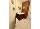 Compact bathroom featuring a small sink with a dark wooden cabinet and decorations at 11457 Steponia Bay St, Las Vegas, NV 89141