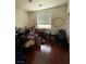 Untidy bedroom featuring hardwood floors, window with blinds, and minimal decor at 11457 Steponia Bay St, Las Vegas, NV 89141