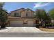Two-story home featuring a spacious three-car garage and desert landscaping at 11457 Steponia Bay St, Las Vegas, NV 89141