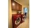 Well-organized laundry room featuring a red front-loading washer and dryer at 11457 Steponia Bay St, Las Vegas, NV 89141